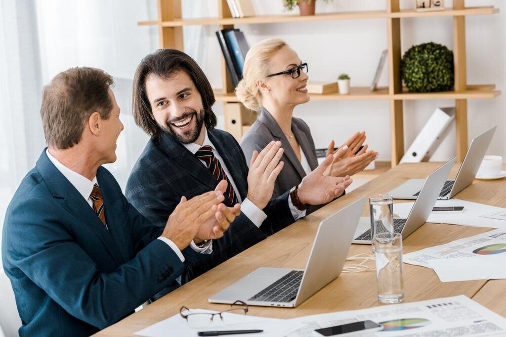 stock-photo-happy-business-people-clapping-hands.jpg